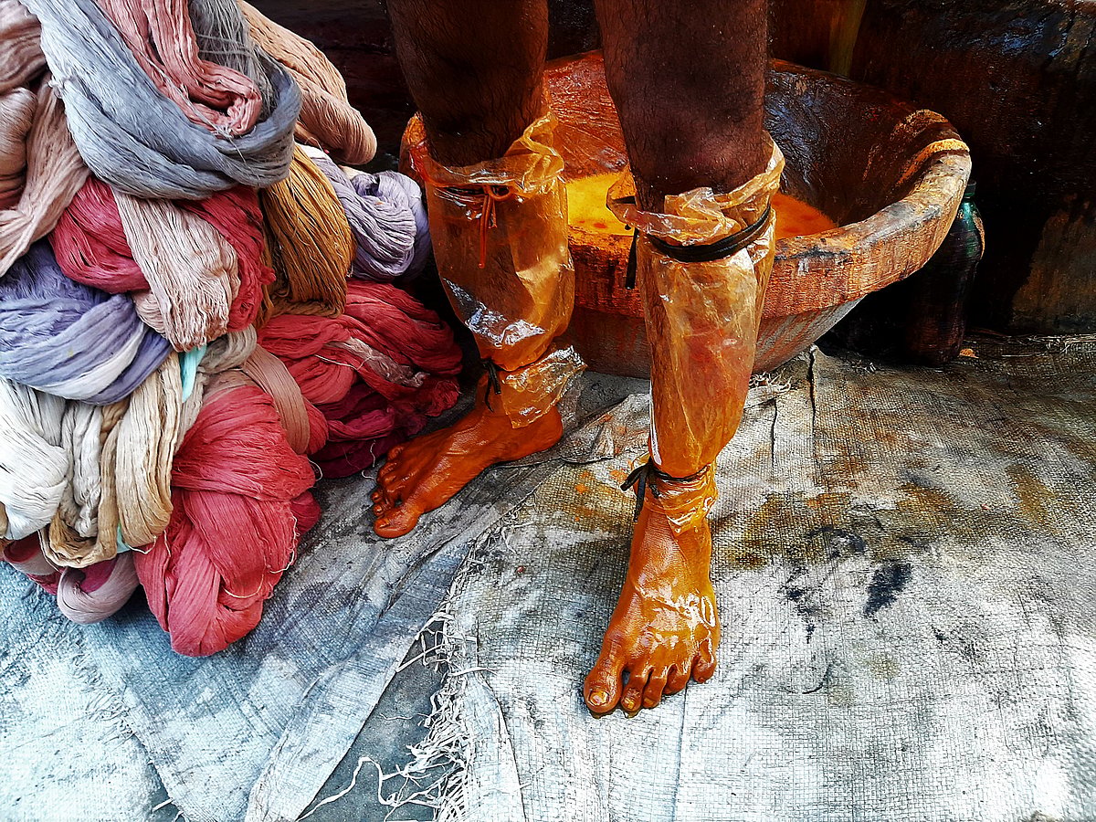 Feet wrapped in polythene to keep the dye off.