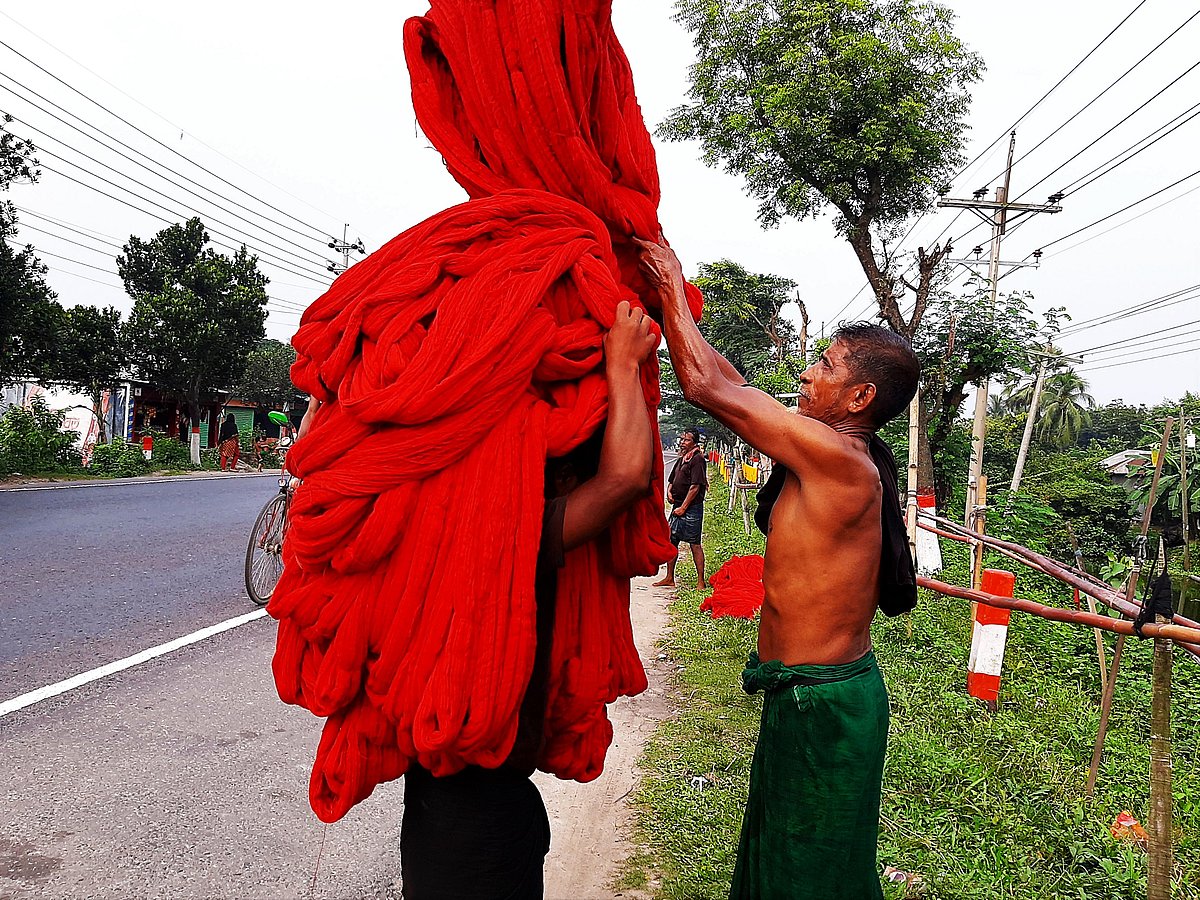 Yarn covers a worker's face.