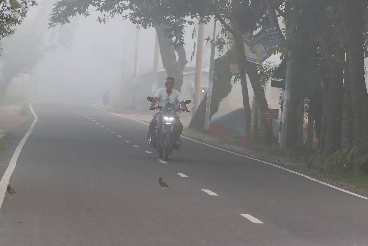 Winter is still some way off, but morning fog has begun. A motorcyclist on a misty road. Kadamtala, Rangpur, 28 September. Photo: Moinul Islam