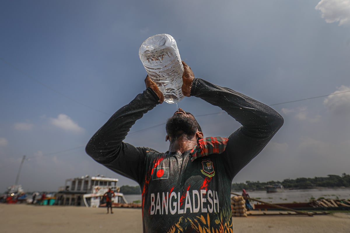 প্রচণ্ড গরমে পানি খেয়ে তৃষ্ণা মেটাচ্ছেন এক শ্রমিক। ৫ নম্বর ঘাট, খুলনা (ছবি: সাদ্দাম হোসেন)